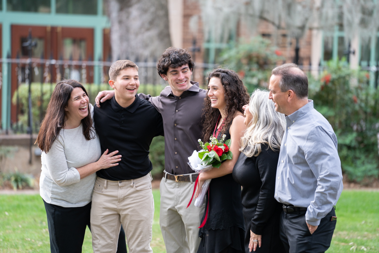 family gathers for photos after winter graduation at the College of Charleston