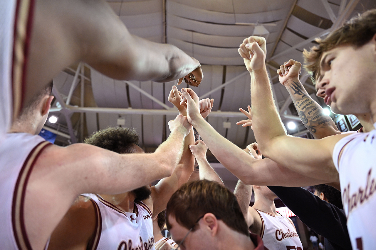 looking up in the huddle at the men's basketball team 