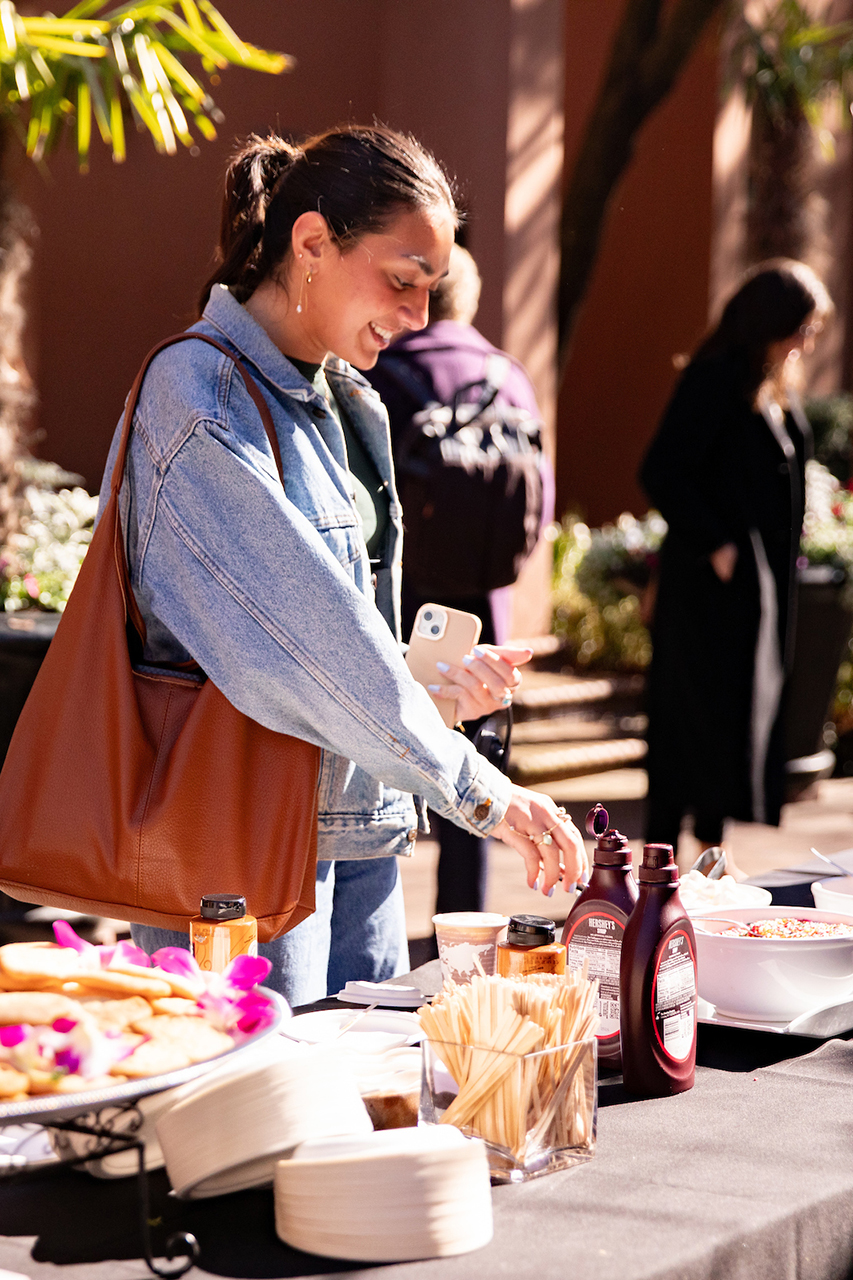 Students enjoy a free hot chocolate bar provided by the School of Humanities and Social Sciences in Cougar Mall.