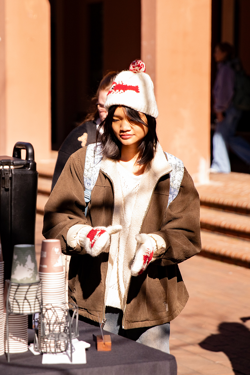 Students enjoy a free hot chocolate bar provided by the School of Humanities and Social Sciences in Cougar Mall.