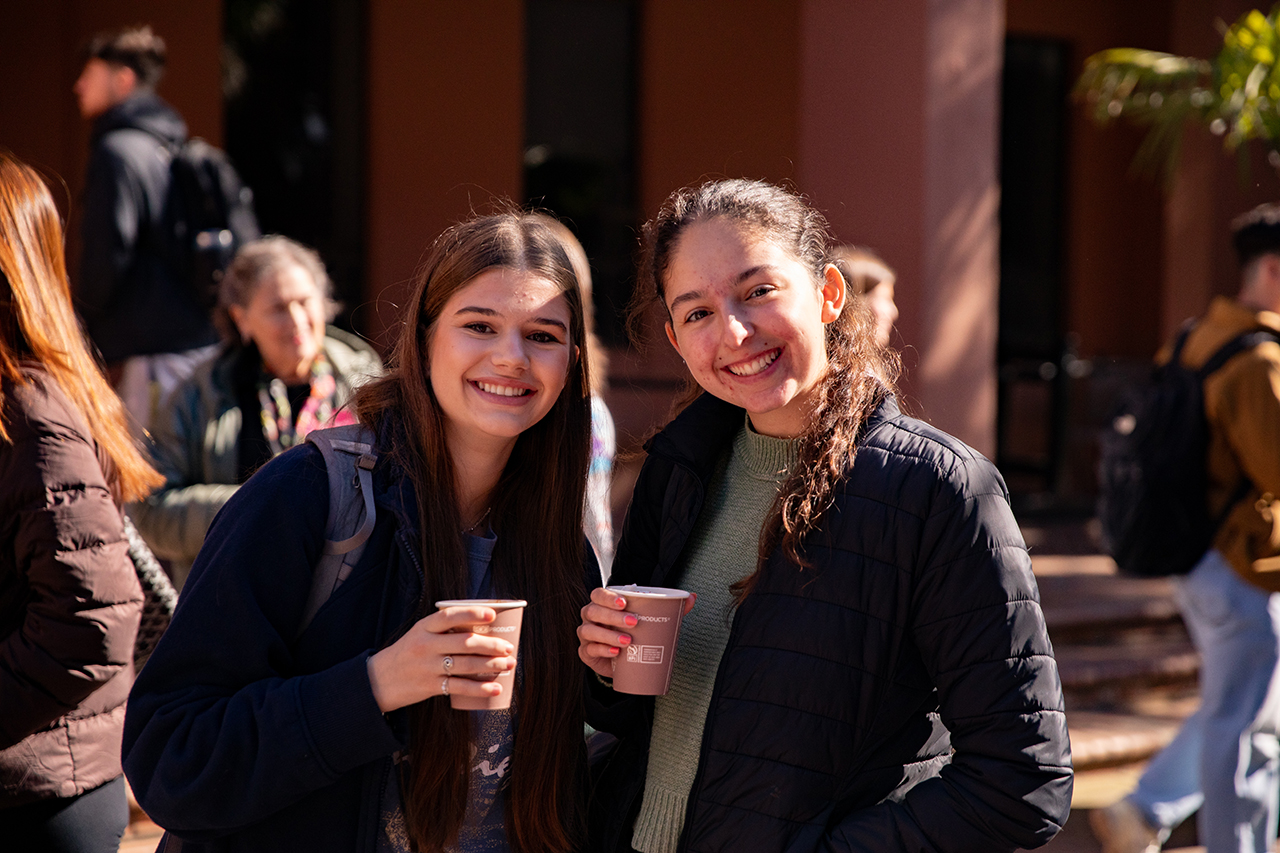 Students enjoy a free hot chocolate bar provided by the School of Humanities and Social Sciences in Cougar Mall.