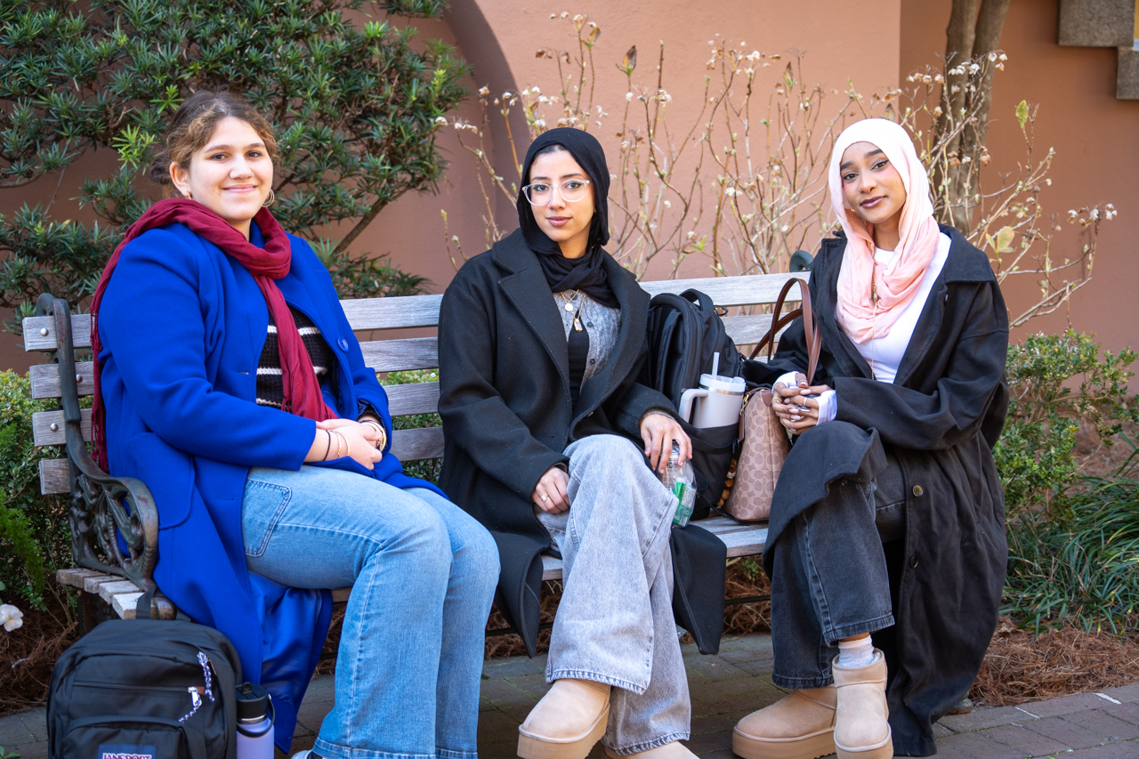 friends sitting on bench on winter day 