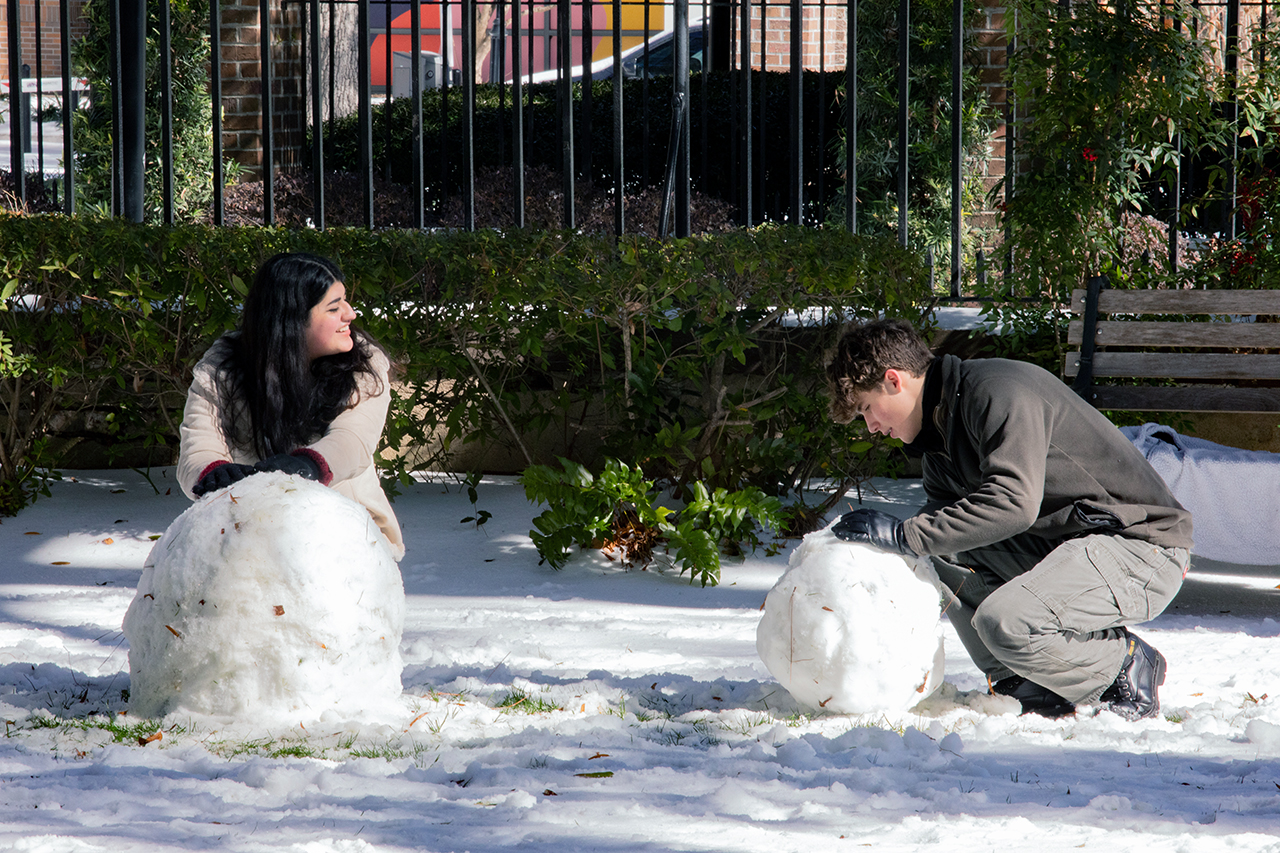 Charleston students and members of the community walk around and do snow activities in the Cistern