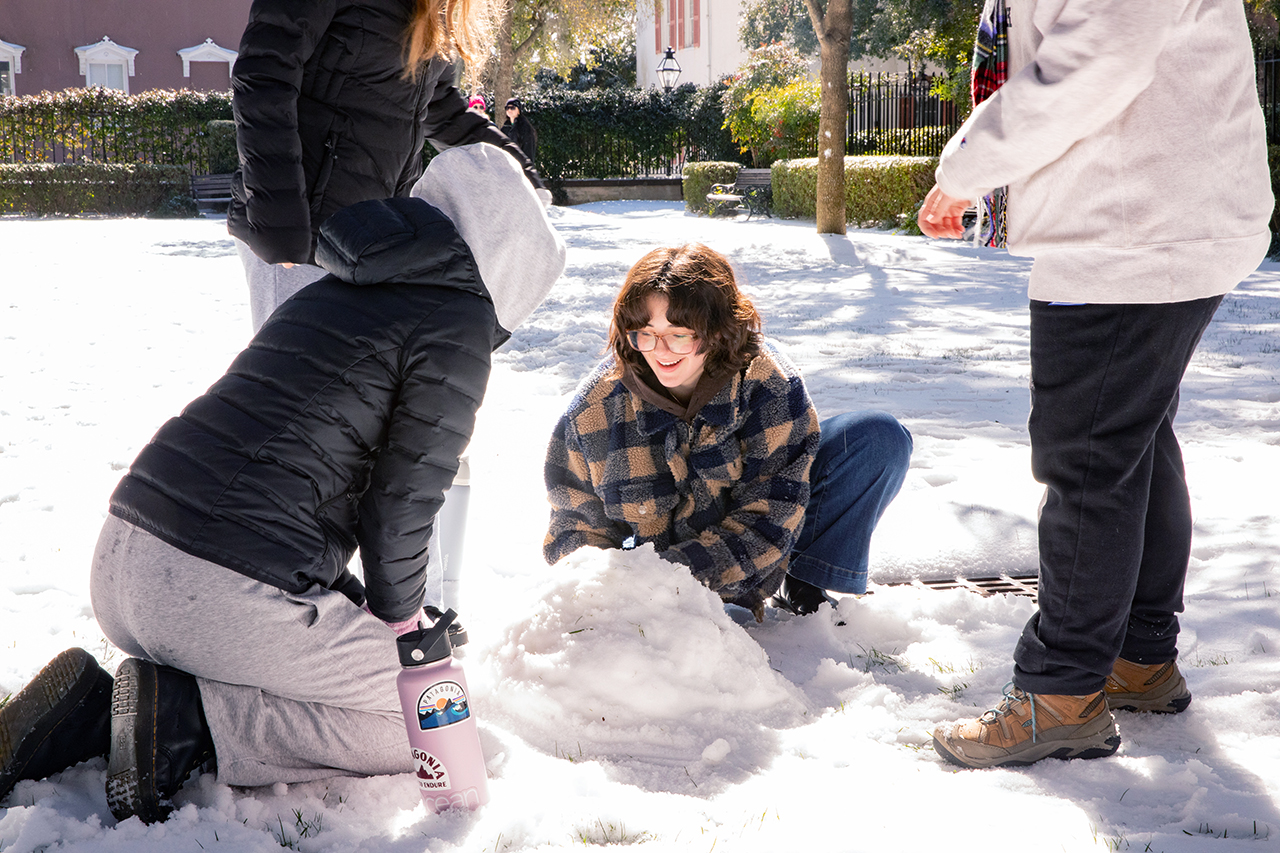 Charleston students and members of the community walk around and do snow activities in the Cistern