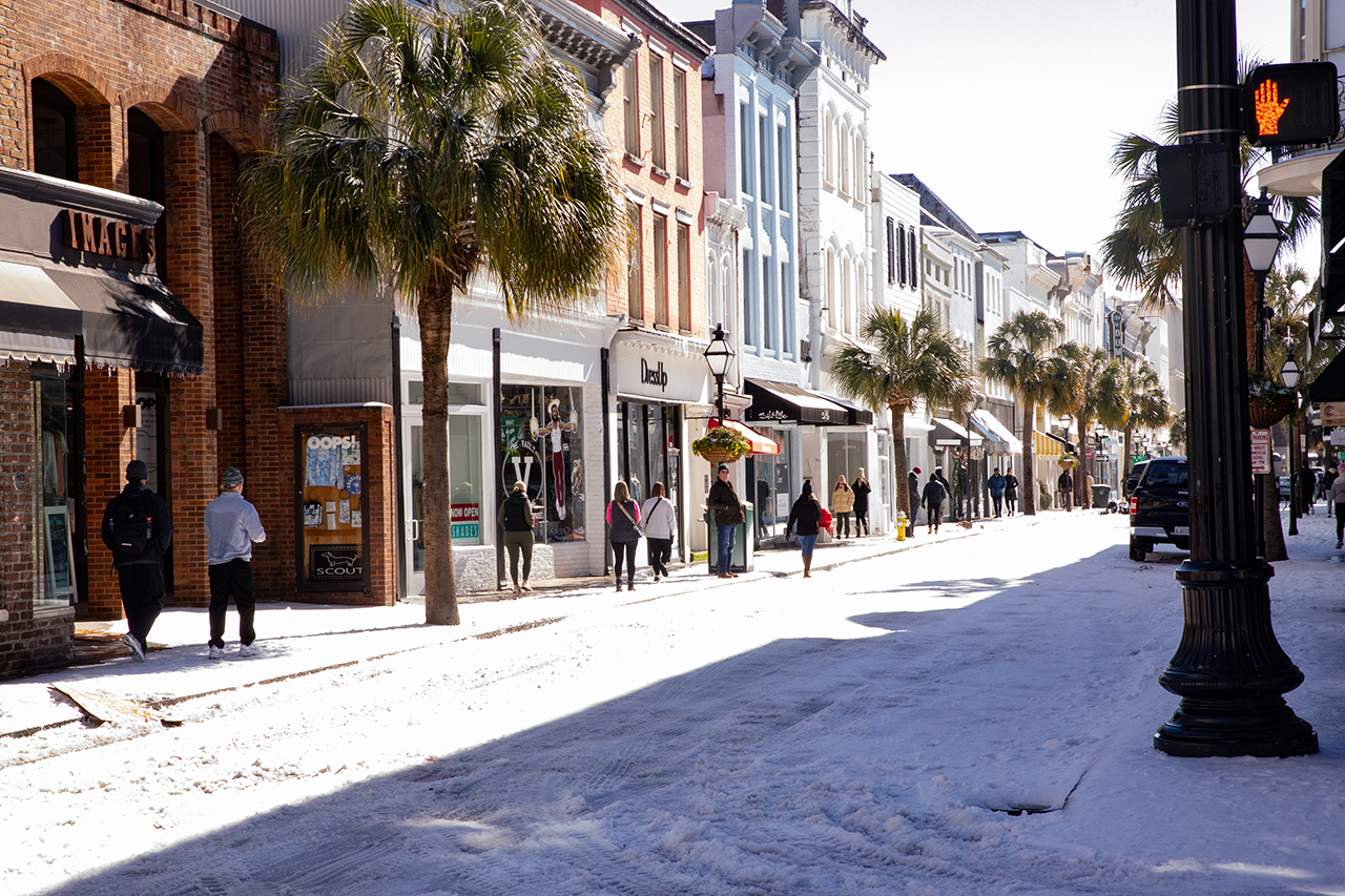 CofC's campus and King Street busy with students and members of the community exploring the snowy streets.