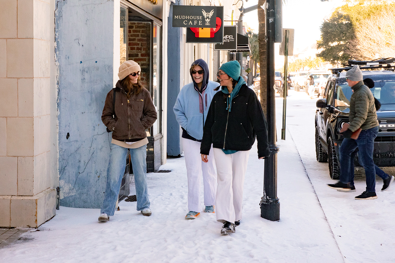 students walk down snowy king street in Charleston 