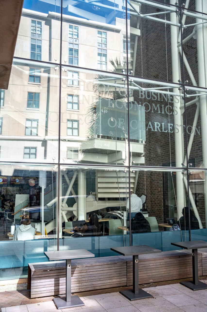 glass windows reflect buildings on campus 