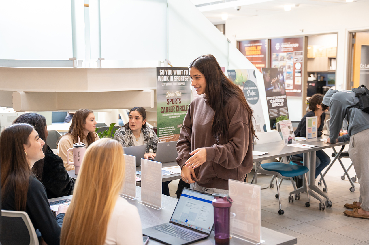 student speaks with peers at business involvement fair 