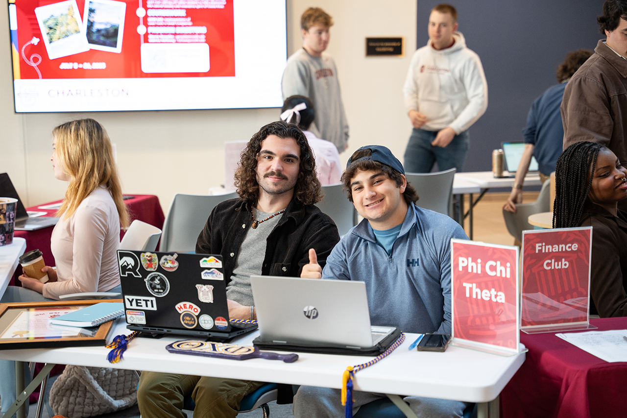 students pose for photos at the business school involvement fair 