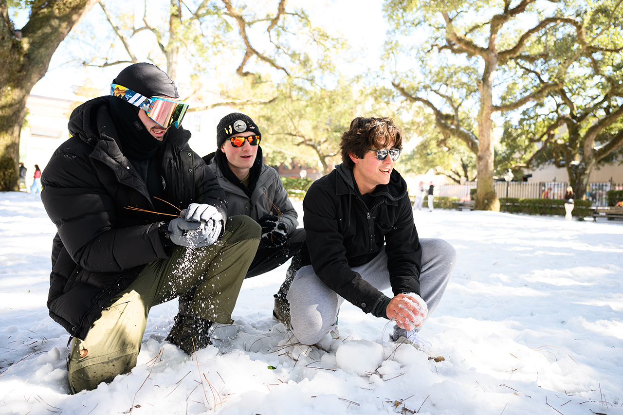 students have snow fight in the Cistern Yard 