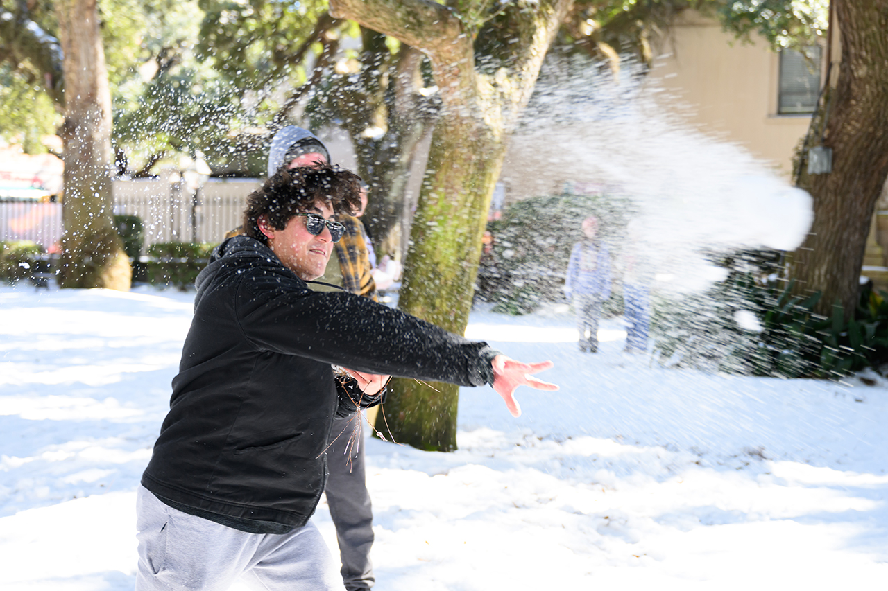 students have snow fight in the Cistern Yard