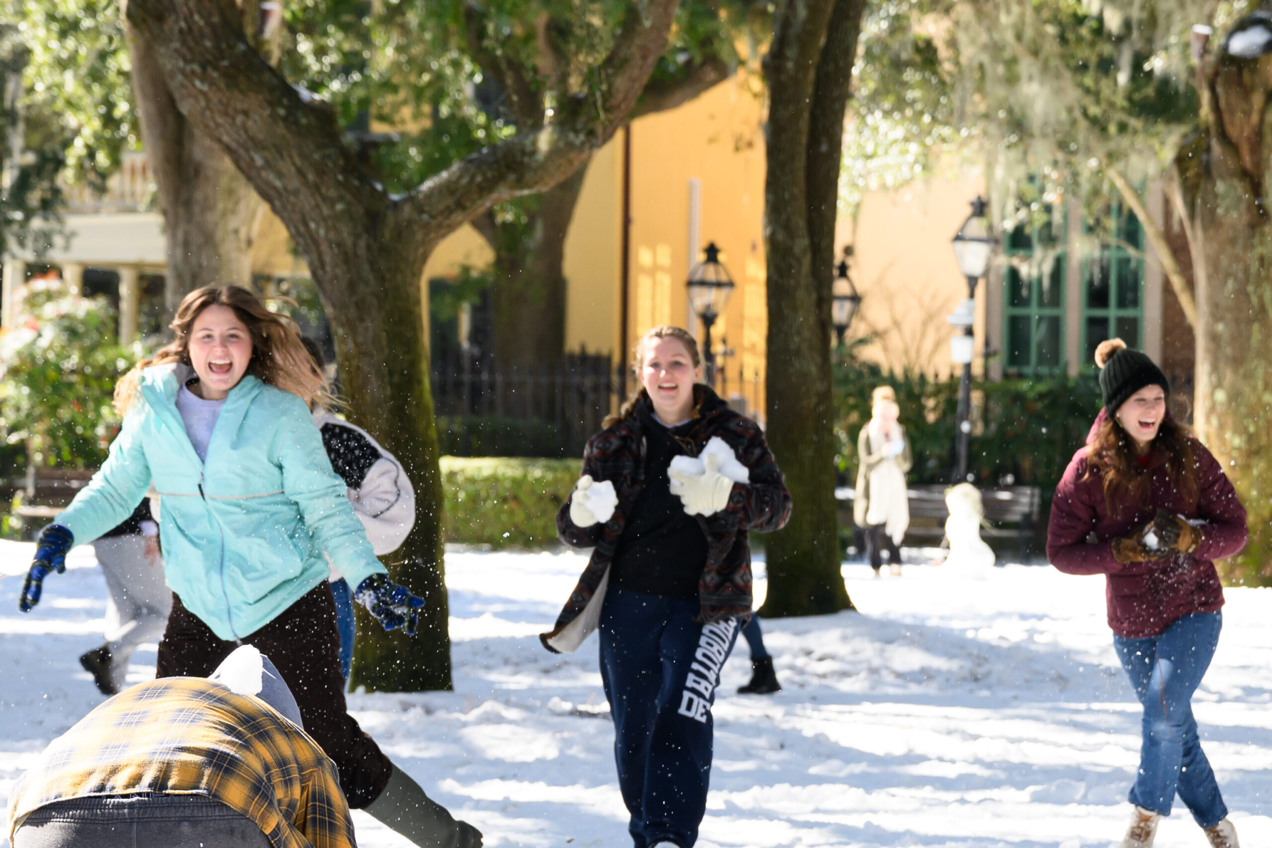 students have snow fight in the Cistern Yard 