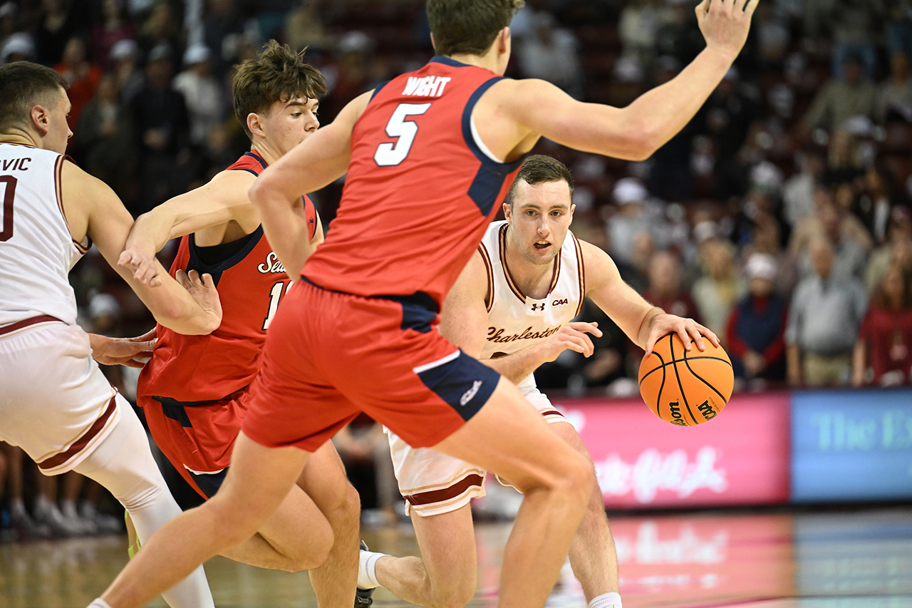 College of Charleston mens basketball team dribbles past opponent