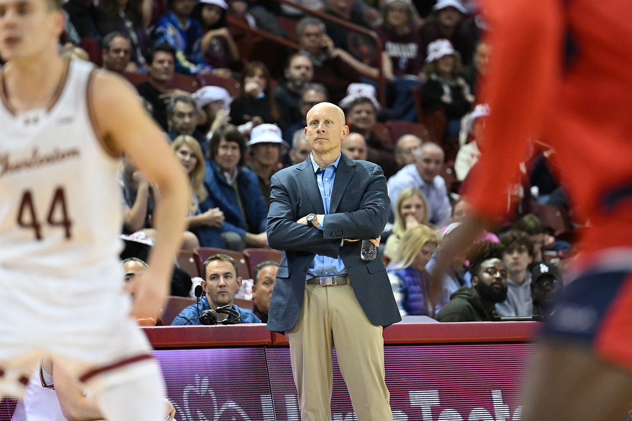 Men's basketball couch watches the game 