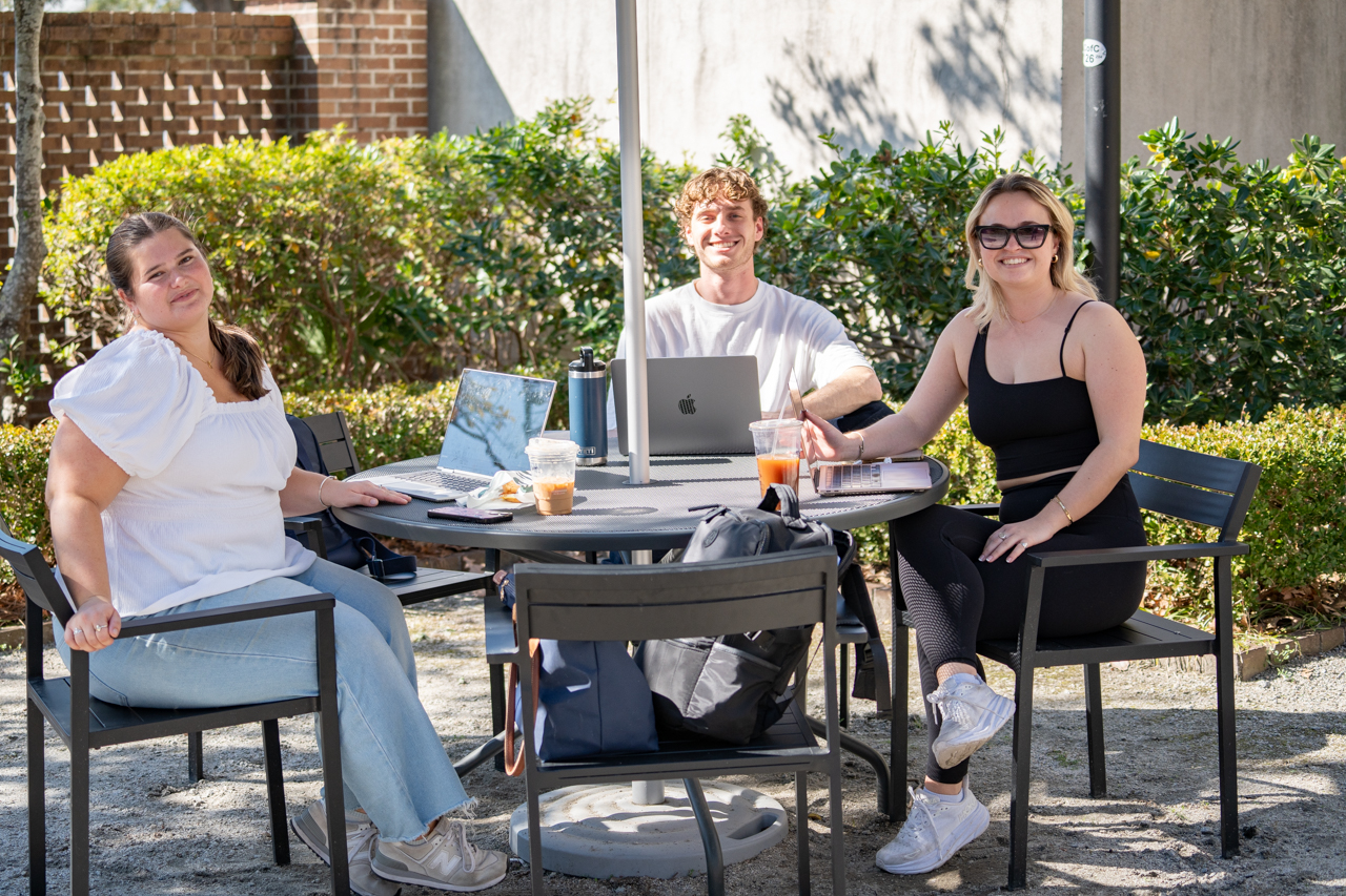 group of students at table outside library