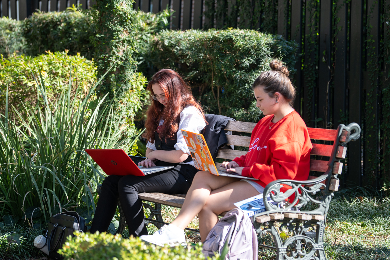 studying outside on a park bench 