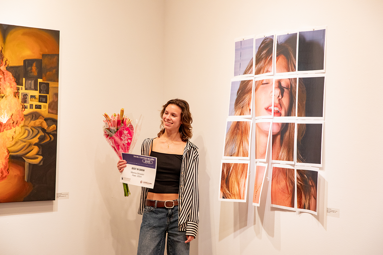 posing next to art at young contemporaries exhibit 