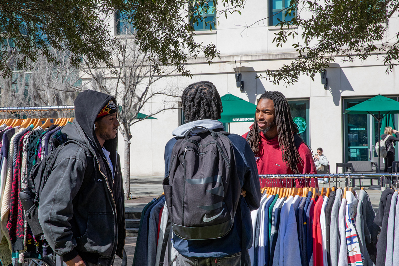 Students shop at a pop-up secondhand clothing market called Flea-Ji put on by the FiJi fraternity at Rivers Green.