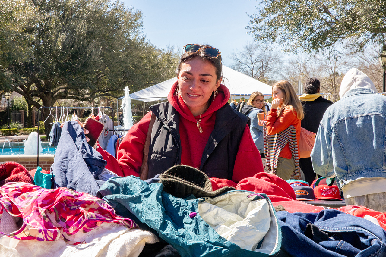 Students shop at a pop-up secondhand clothing market called Flea-Ji put on by the FiJi fraternity at Rivers Green.