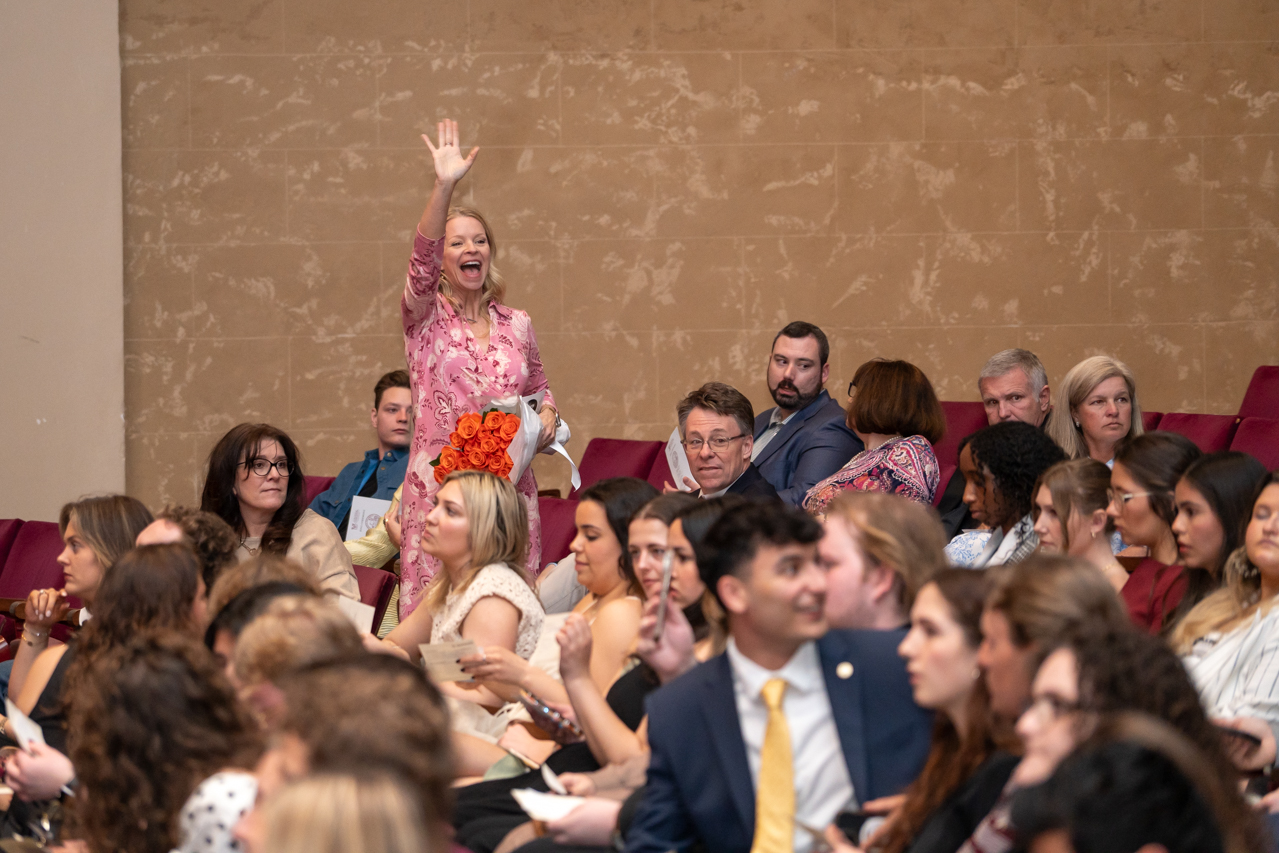 mom waves at child at ring ceremony