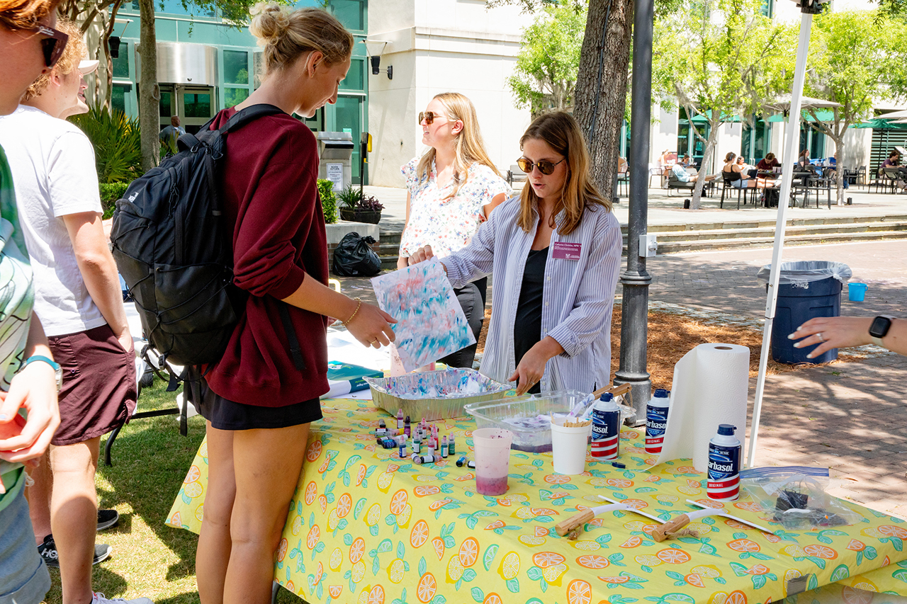 Students attend the Stress Relief Fair in Rivers Green where there are free crafts, food, and therapy dogs.