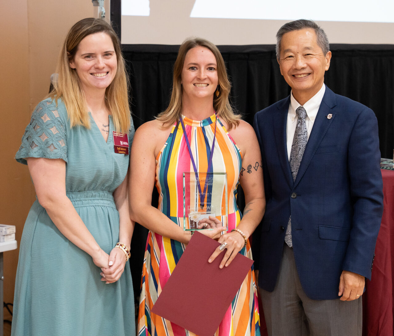 Danielle Wheeler, who won the first-ever Rising Cougar Award, standing with President Andrew T. Hsu and SAC Chair Lindsey Copeland.