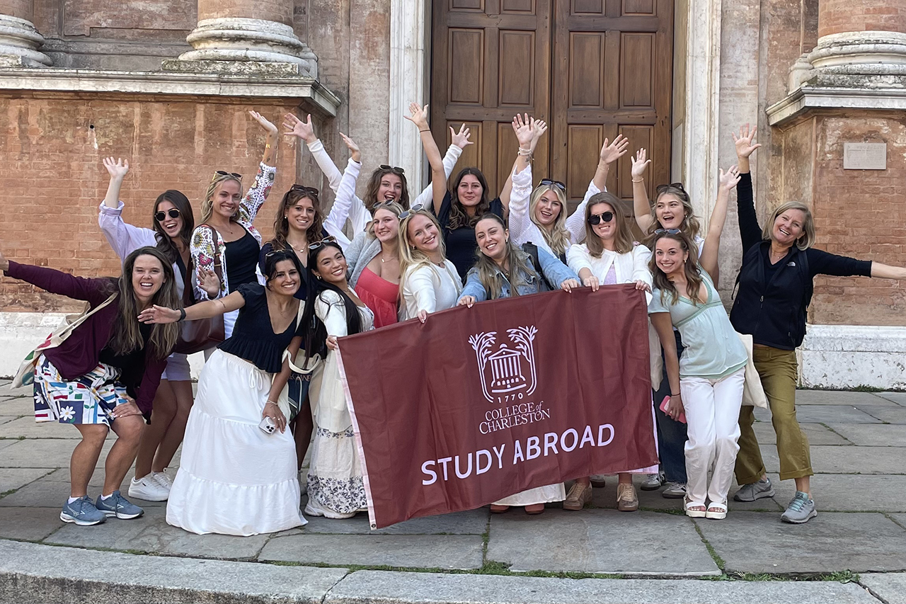 group holding College of Charleston flag in Italy