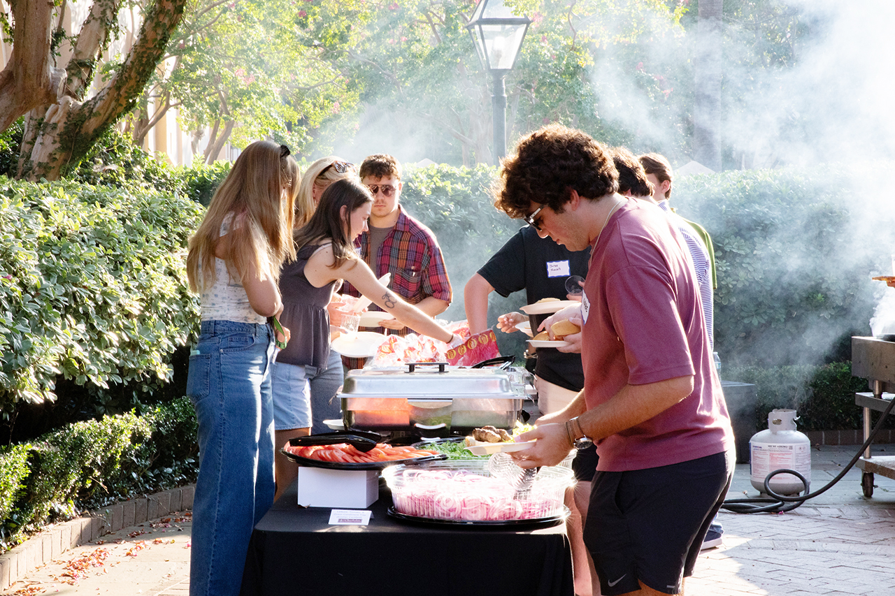 CofC students, alumni, and faculty mingle in the President's house courtyard at the Hillel Welcome Back barbeque.