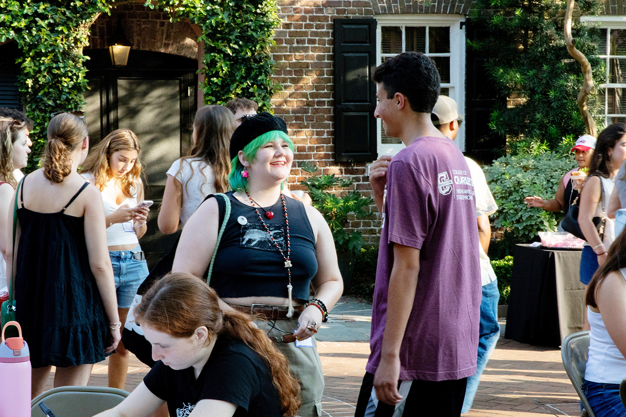CofC students, alumni, and faculty mingle in the President's house courtyard at the Hillel Welcome Back barbeque.