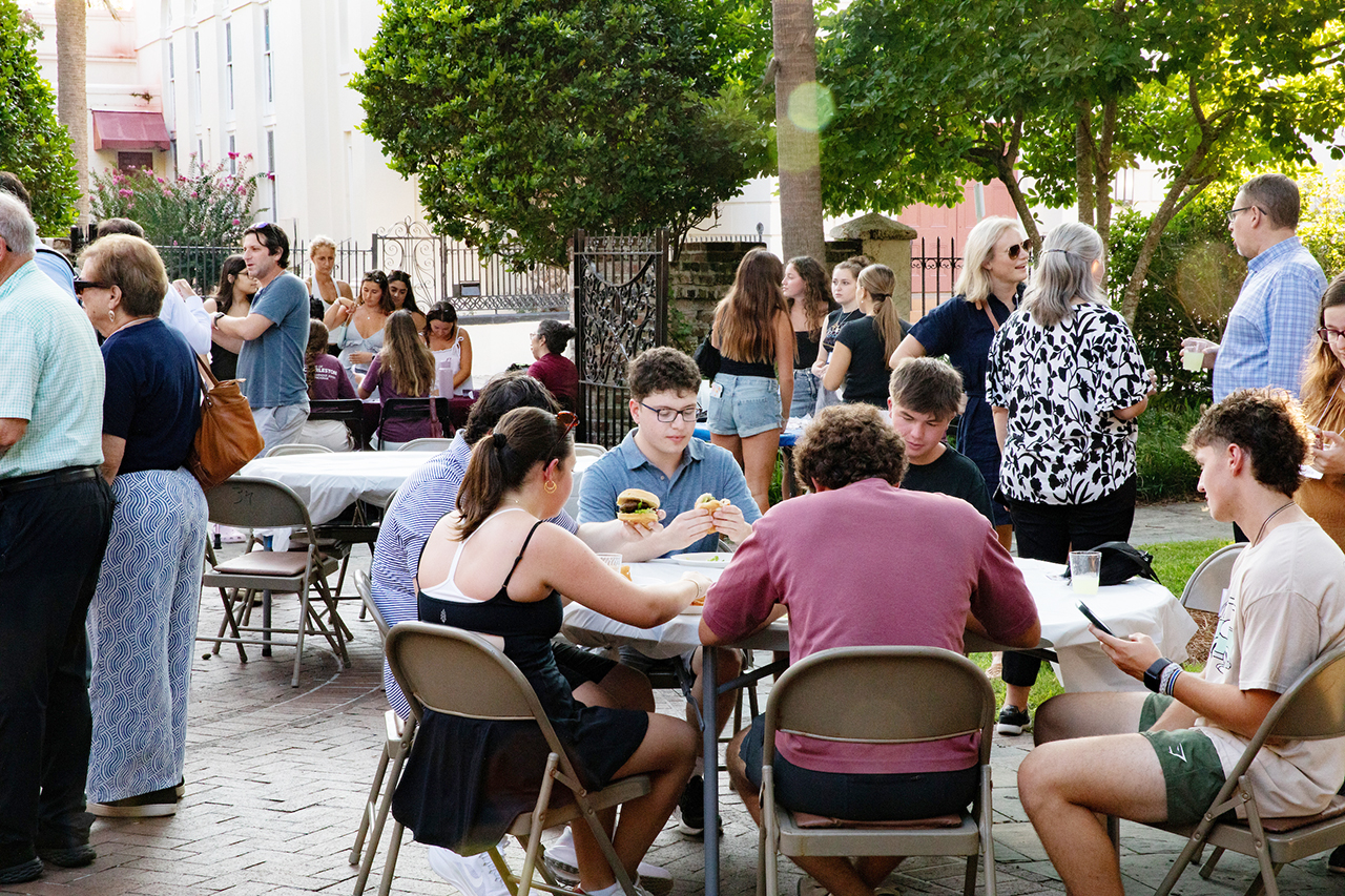 CofC students, alumni, and faculty mingle in the President's house courtyard at the Hillel Welcome Back barbeque.