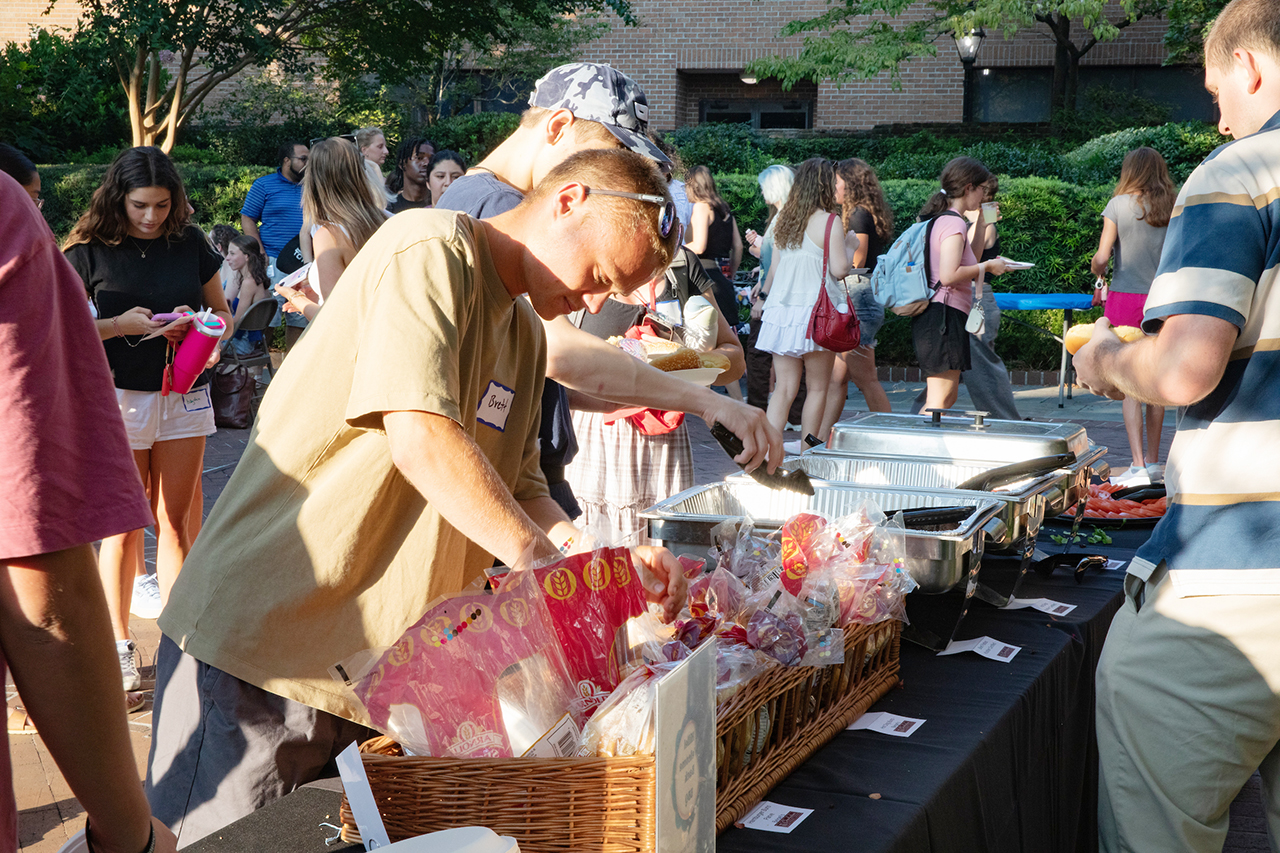 CofC students, alumni, and faculty mingle in the President's house courtyard at the Hillel Welcome Back barbeque.