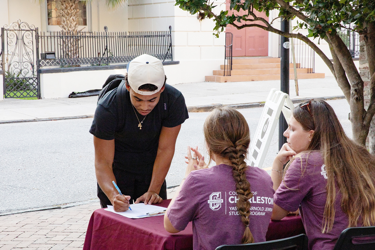 CofC students, alumni, and faculty mingle in the President's house courtyard at the Hillel Welcome Back barbeque.