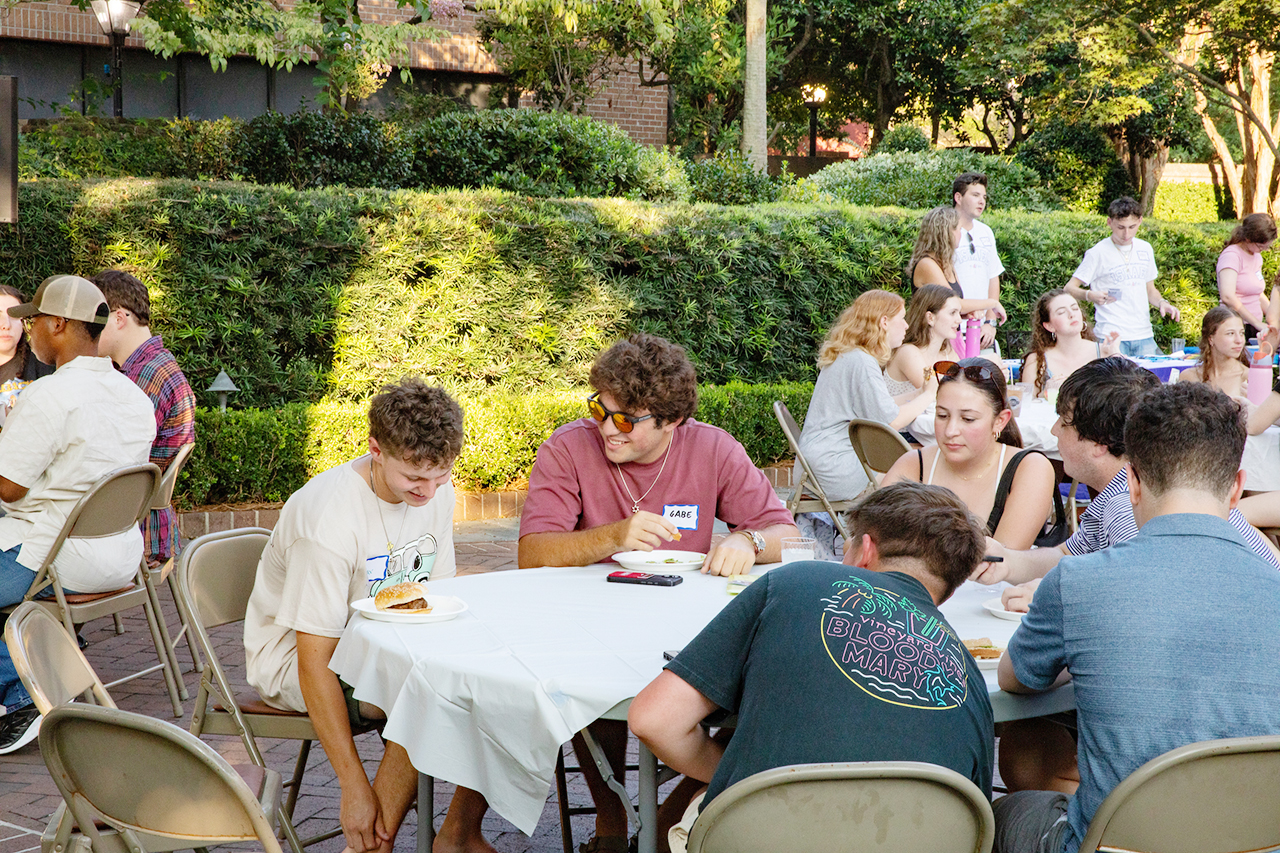 CofC students, alumni, and faculty mingle in the President's house courtyard at the Hillel Welcome Back barbeque.