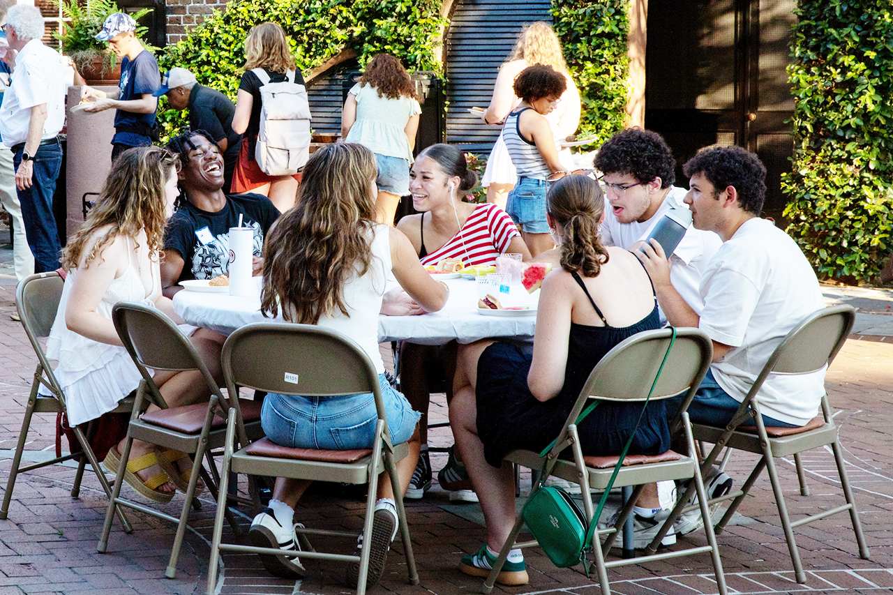 CofC students, alumni, and faculty mingle in the President's house courtyard at the Hillel Welcome Back barbeque.