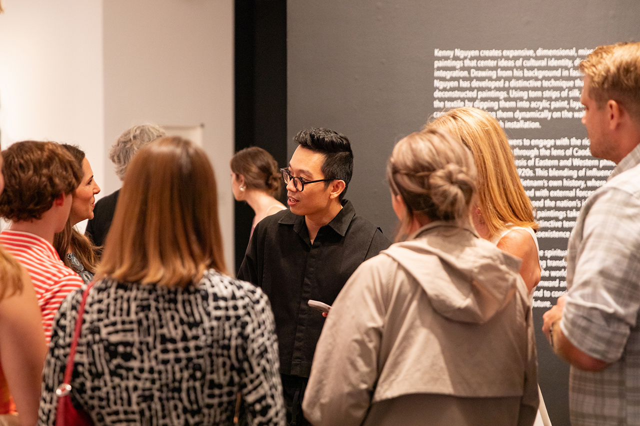 Students, faculty, and members of the community mingle, admire, and interact with Kenny Nguyen's exhibit at Halsey's Opening Reception.