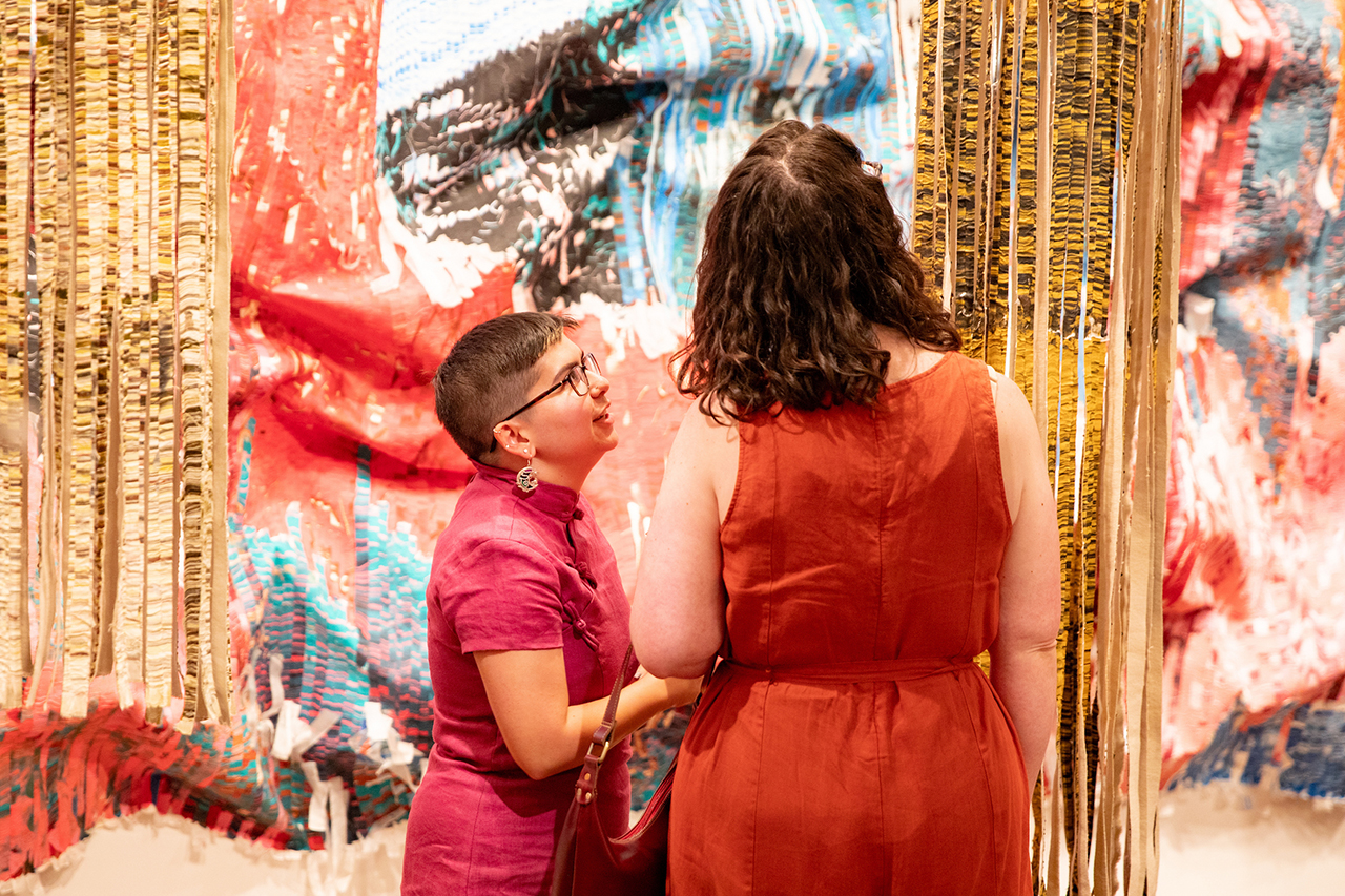 Students, faculty, and members of the community mingle, admire, and interact with Kenny Nguyen's exhibit at Halsey's Opening Reception.