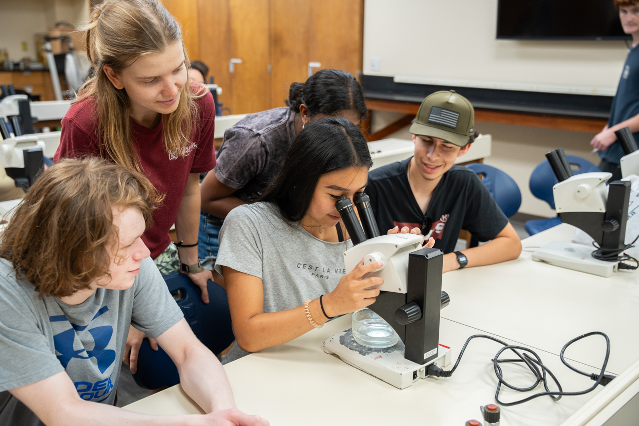students engage with microscope at STEM lab in Grice