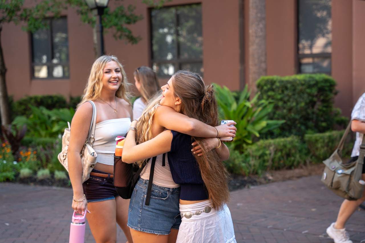 students hugging friends 