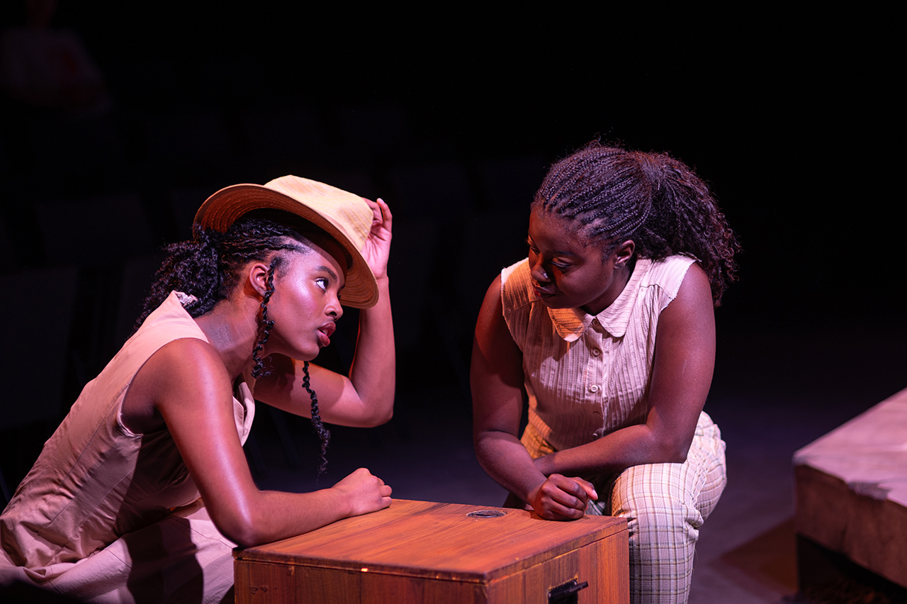 students acting in play titled "Home"