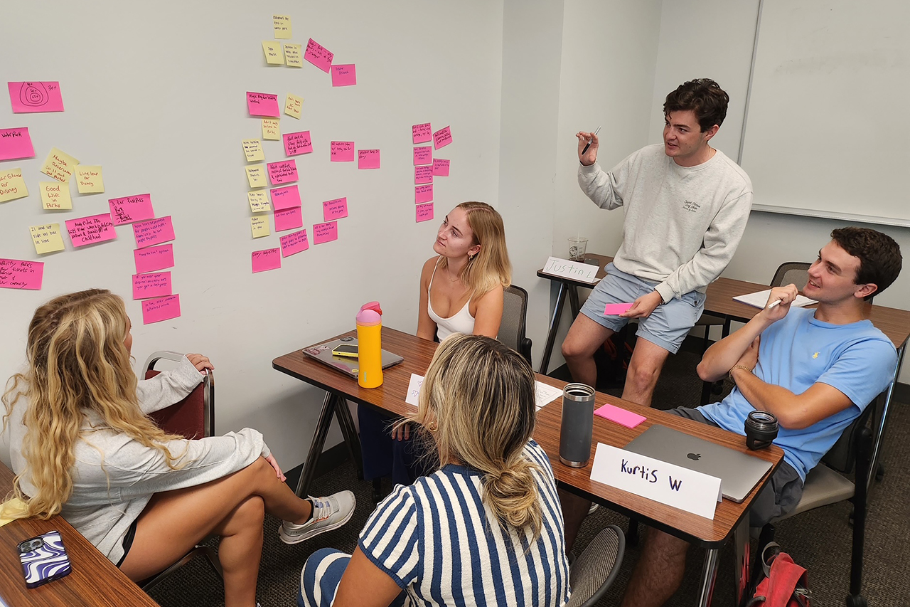 students plan with post-its on wall