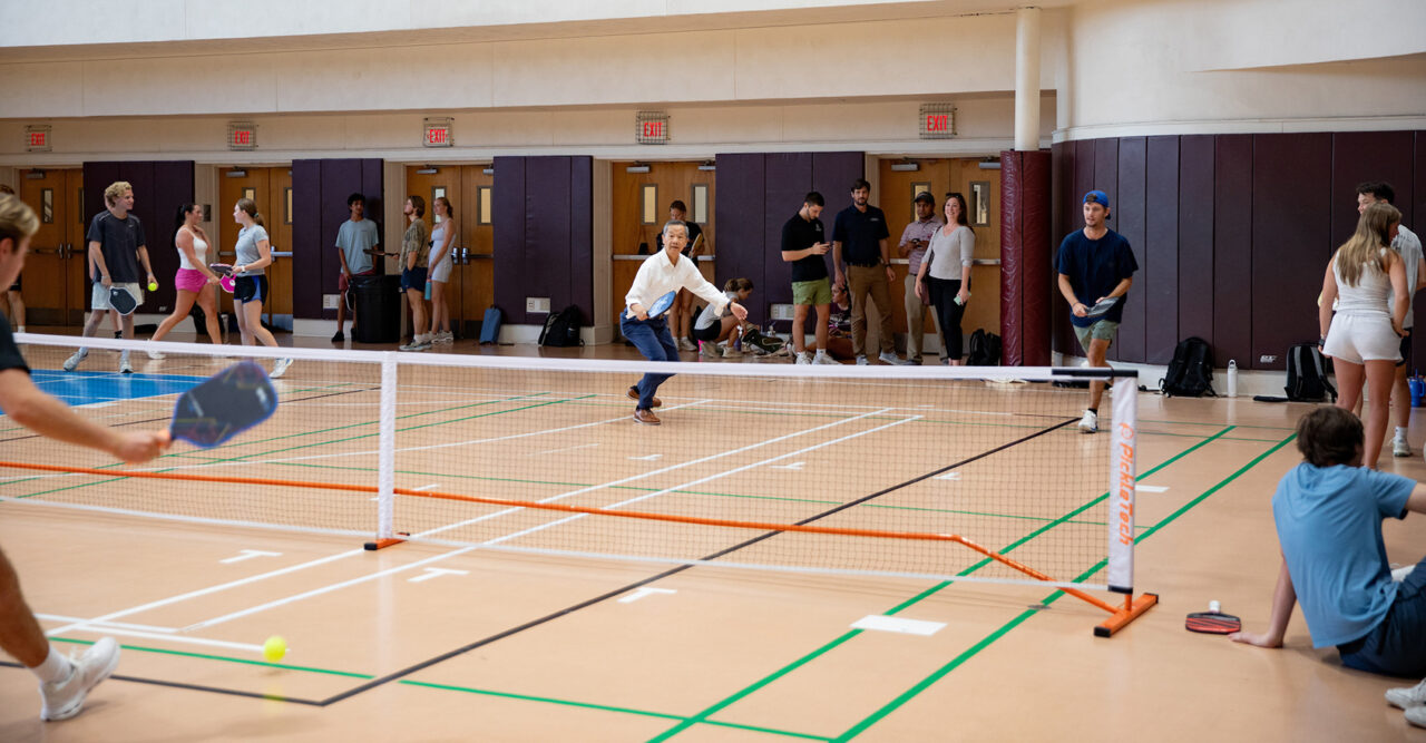 Students play a game of pickleball with President Hsu on the Johnson Center Gym courts.