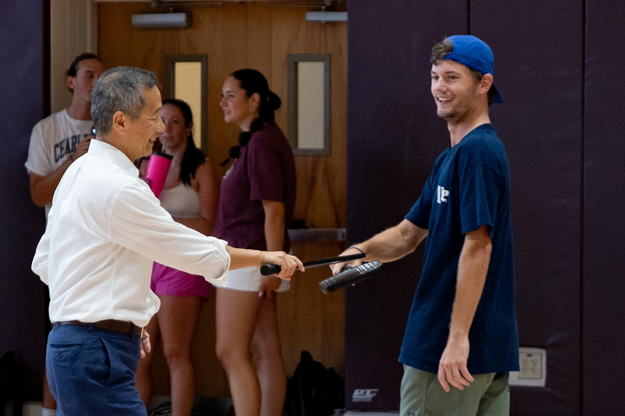 Students play a game of pickleball with President Hsu on the Johnson Center Gym courts.