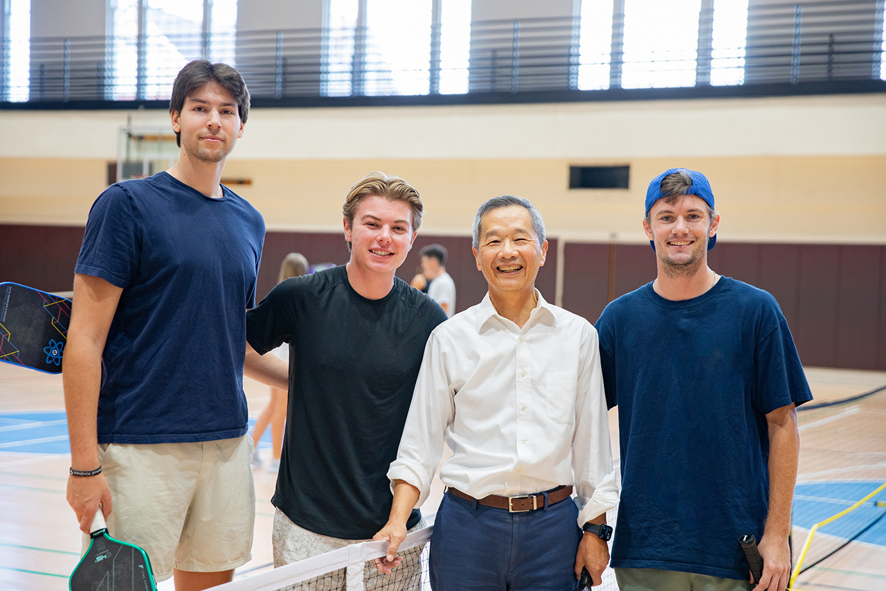 Students play a game of pickleball with President Hsu on the Johnson Center Gym courts.
