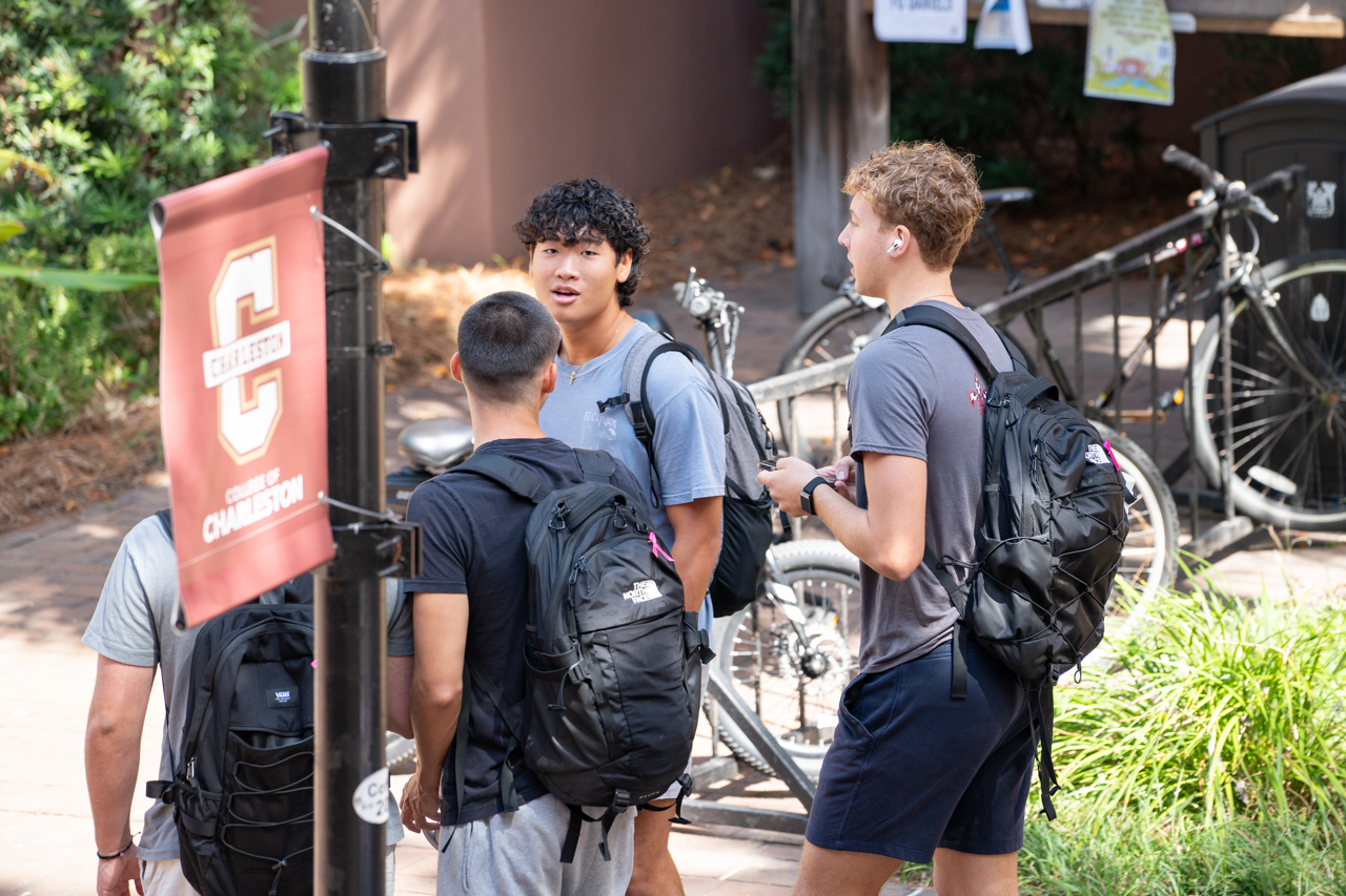 Guys walk around campus together