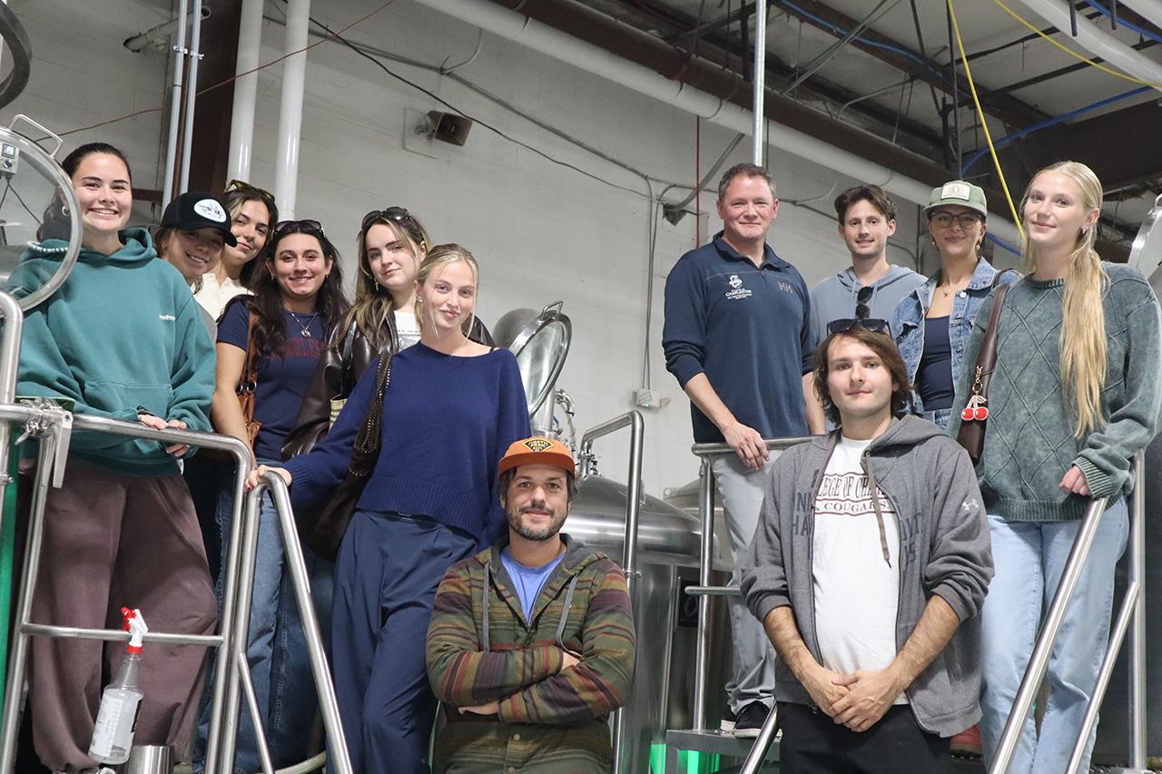 12 people standing in fermentary