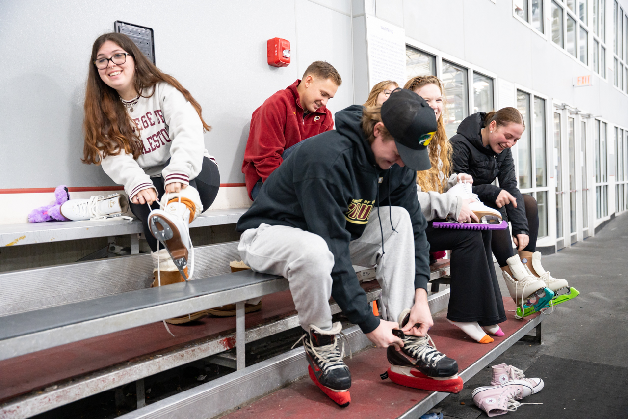 a group of students put on ice skates before class