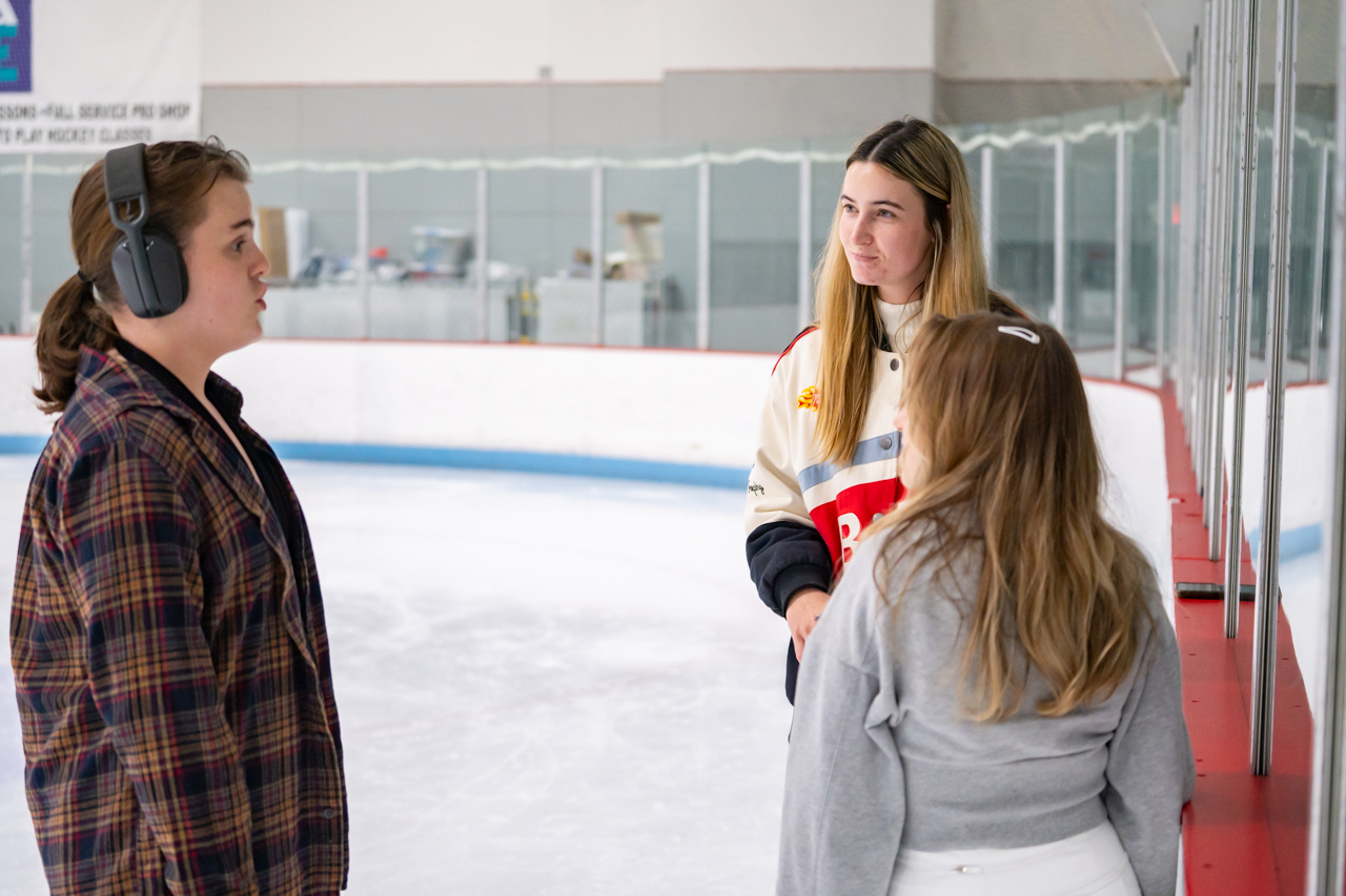 students chat during ice skating class