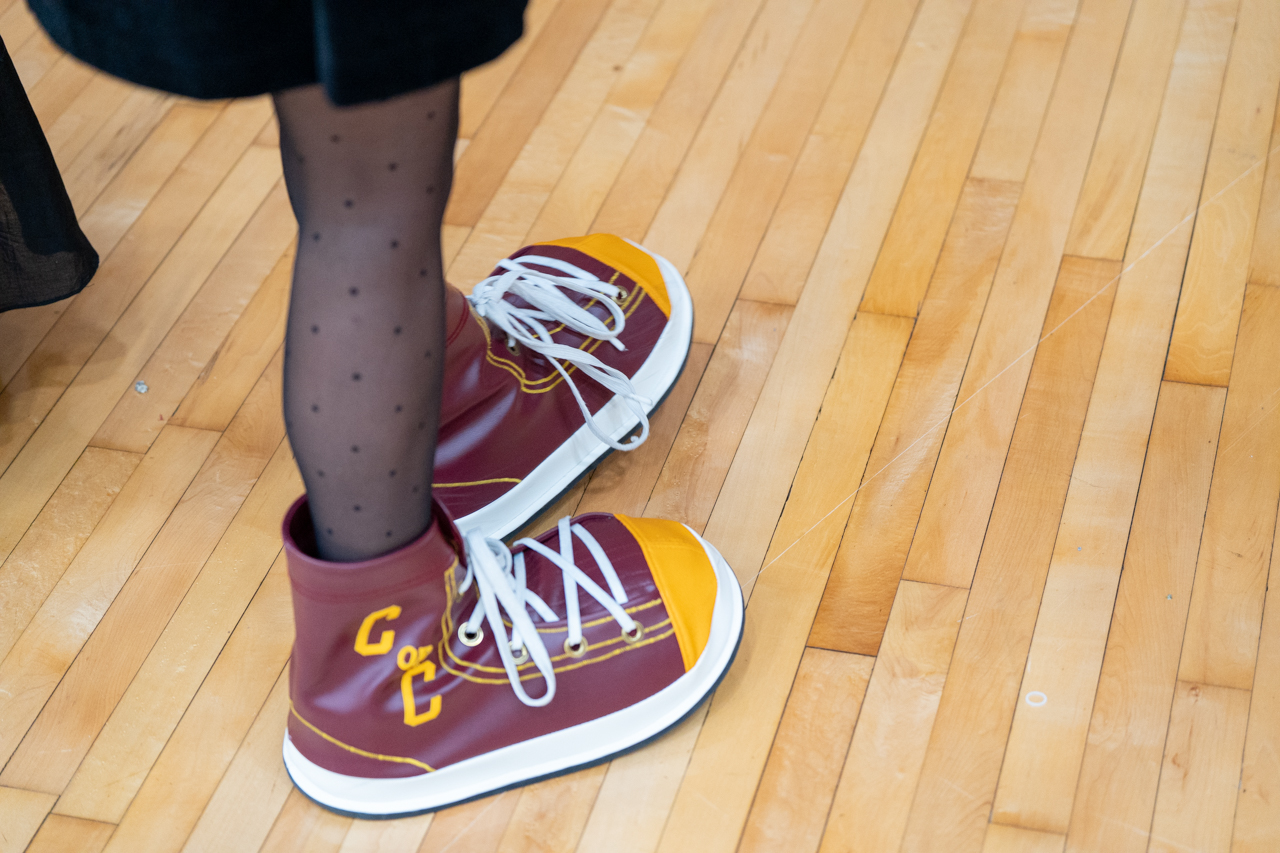 Close up of Clyde sneakers on graduate