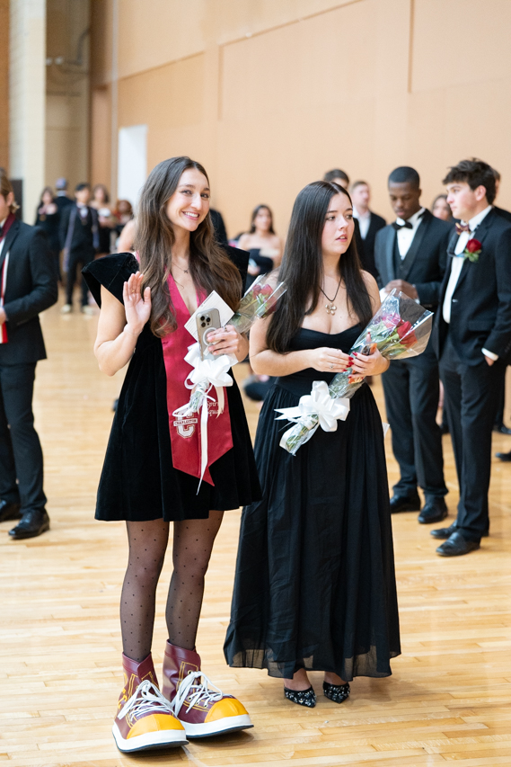 Girl Clyde Graduate waves for camera 