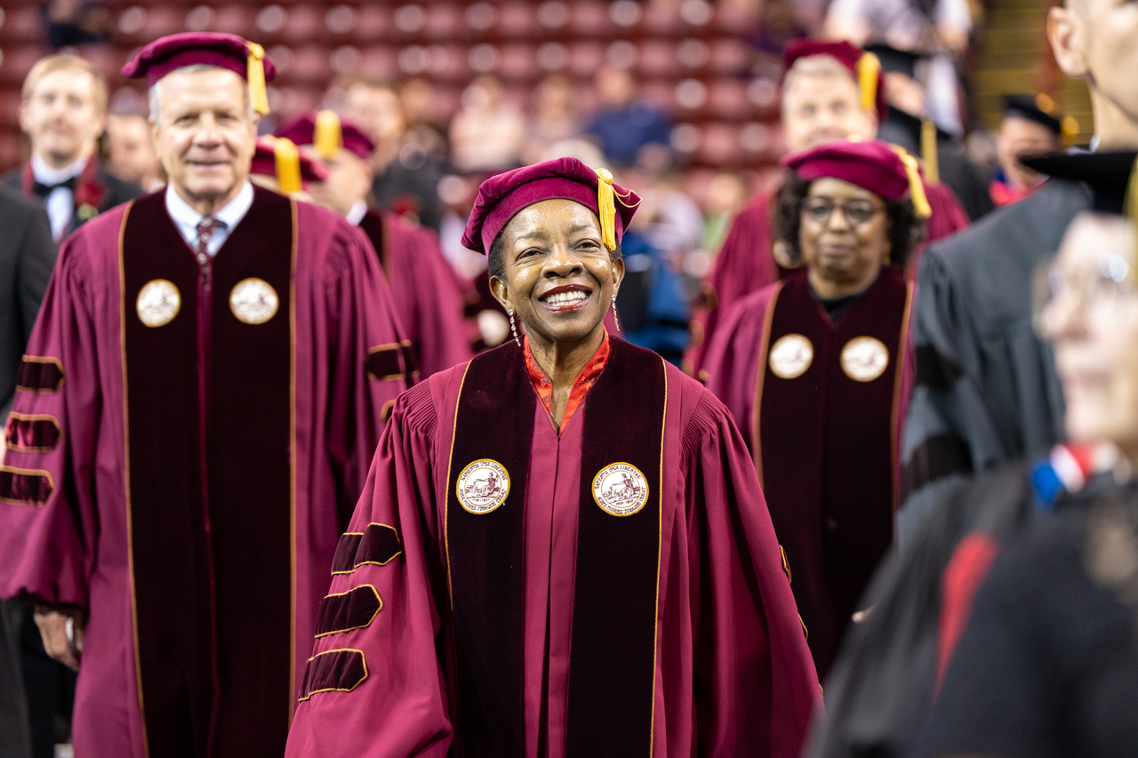 Professor smiles while walking into TD Arena